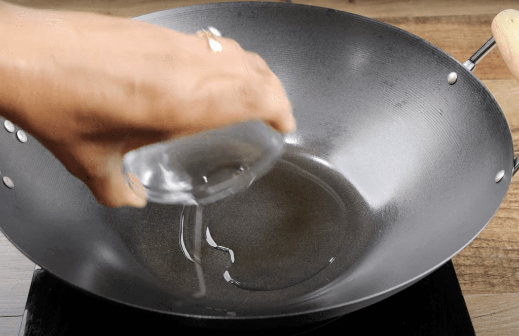 pouring oil in the wok